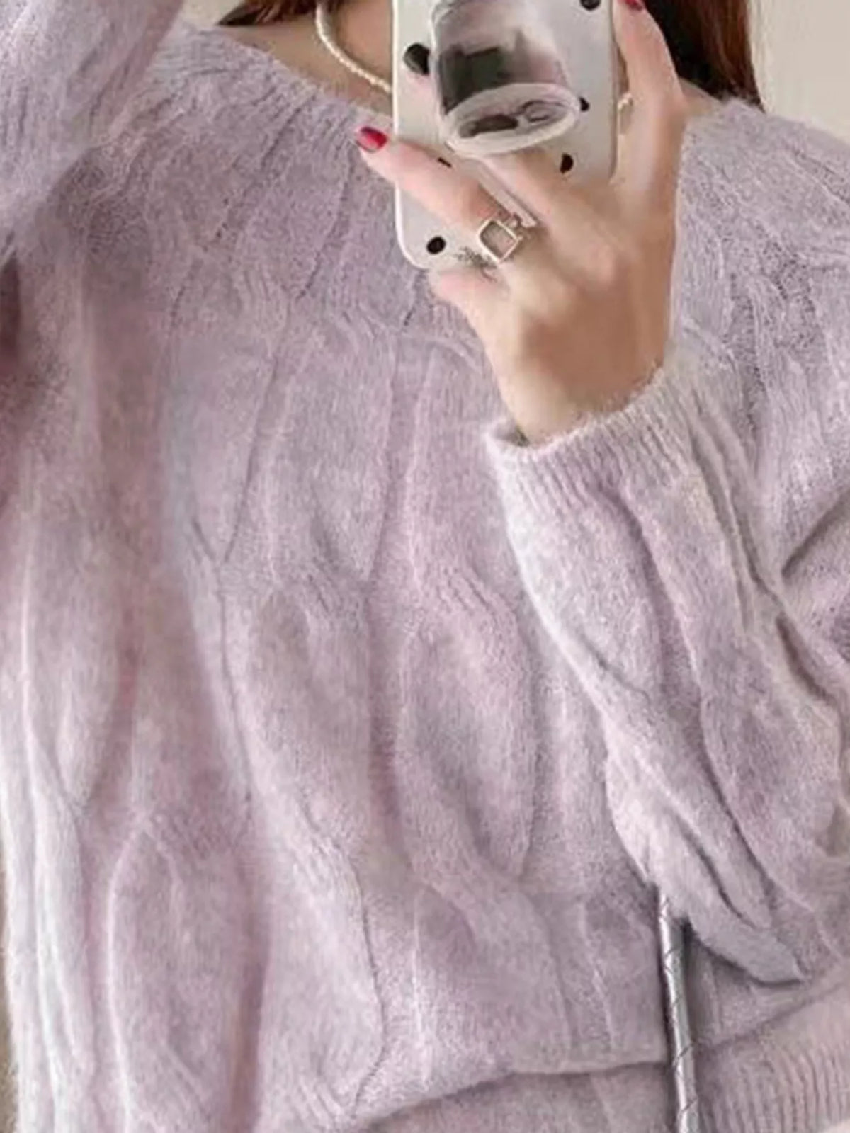 Pink cable-knit round neck sweater with crew neckline and ribbed cuffs