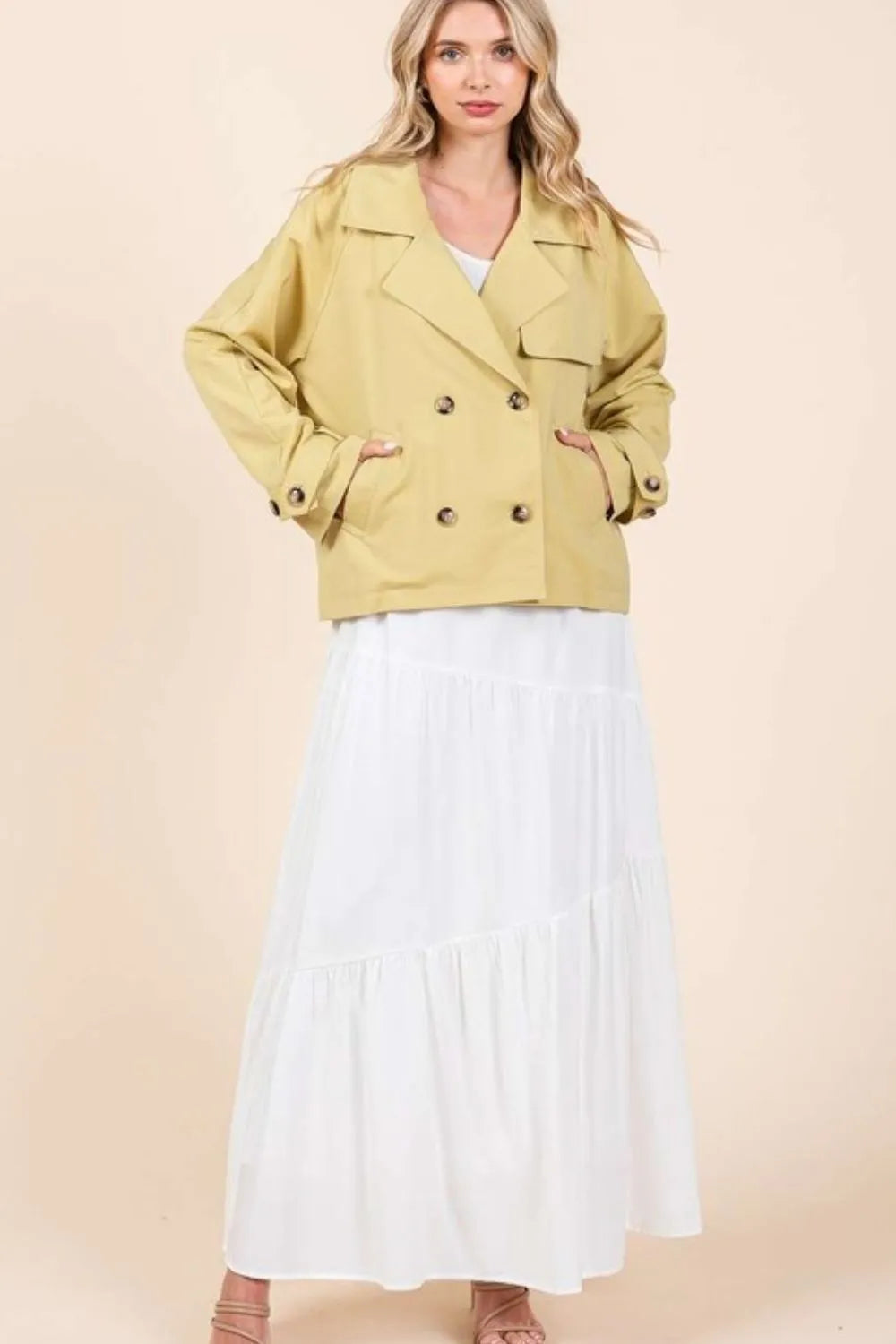 Yellow double-breasted trench coat jacket with long sleeves and structured shoulders