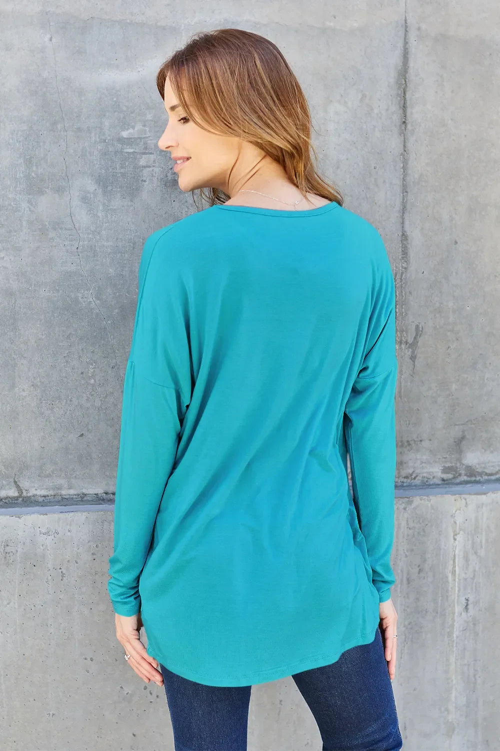Sky blue relaxed long-sleeve tee, back view with crew neck and loose fit