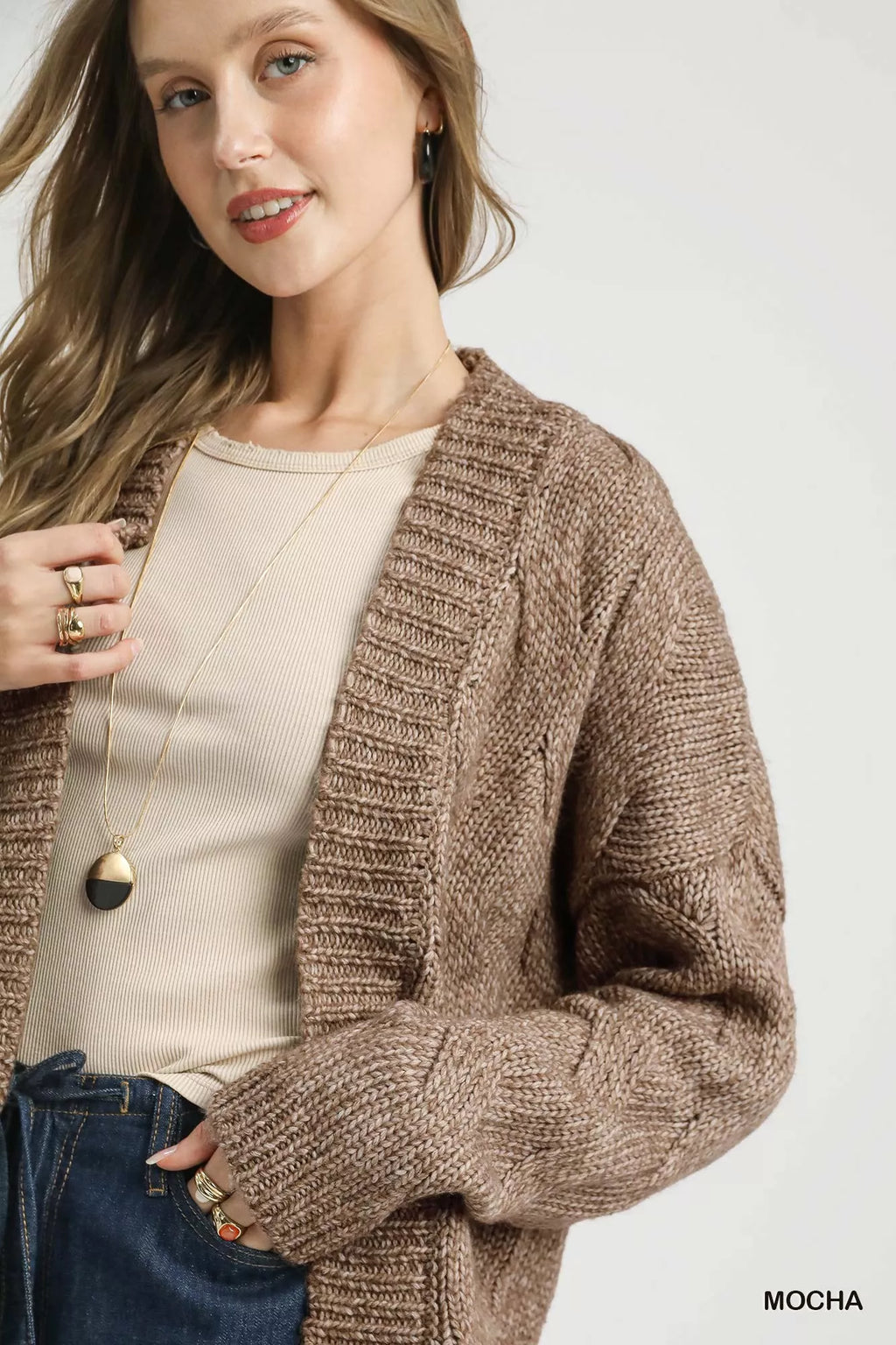 Mocha chunky cable-knit open-front cardigan close-up of textured sleeves and neckline