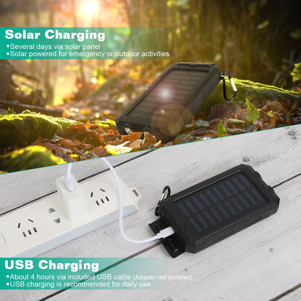Black solar power bank charging with a USB cable, lying on an outdoor surface