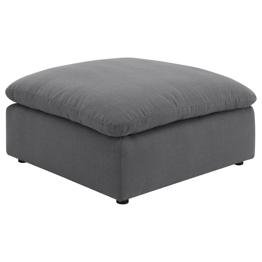 Charcoal upholstered ottoman with padded top cushion and tapered legs