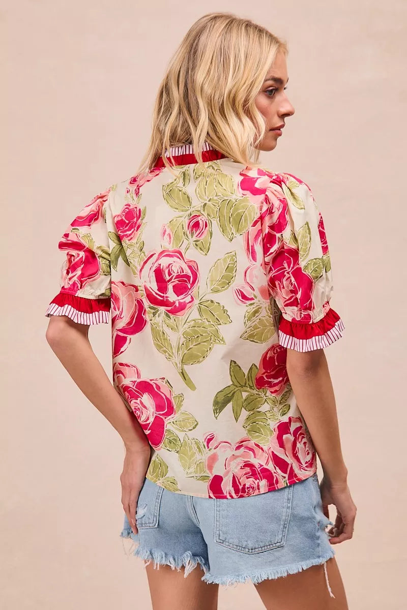Floral woven blouse with coral contrast trim and ruffled short sleeves