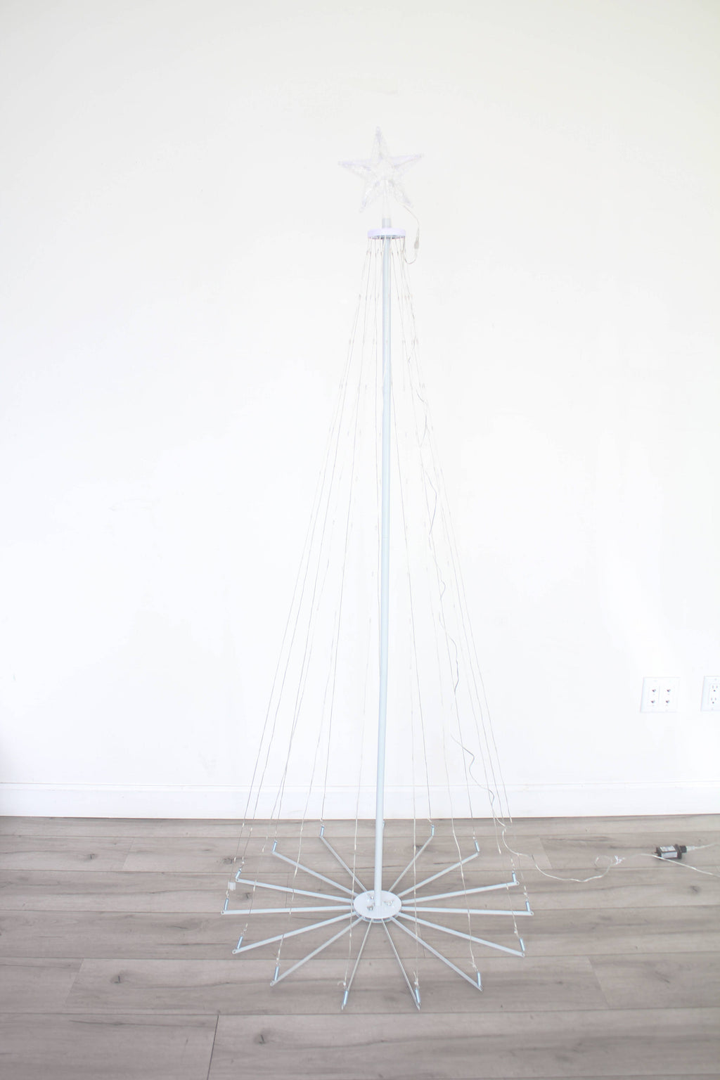 White wireframe outdoor Christmas tree light with star topper, warm white LEDs