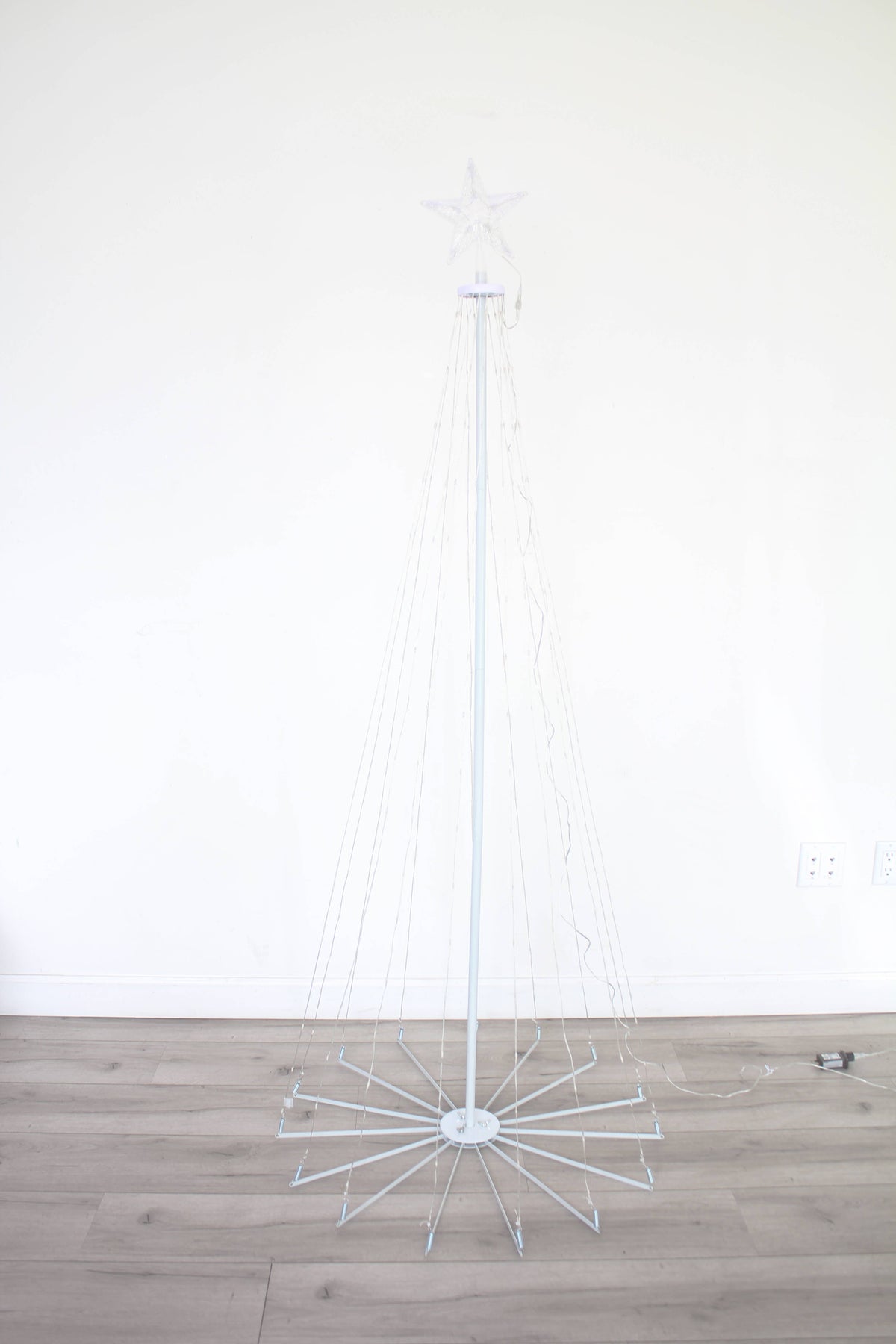 White wireframe outdoor Christmas tree light with star topper, warm white LEDs