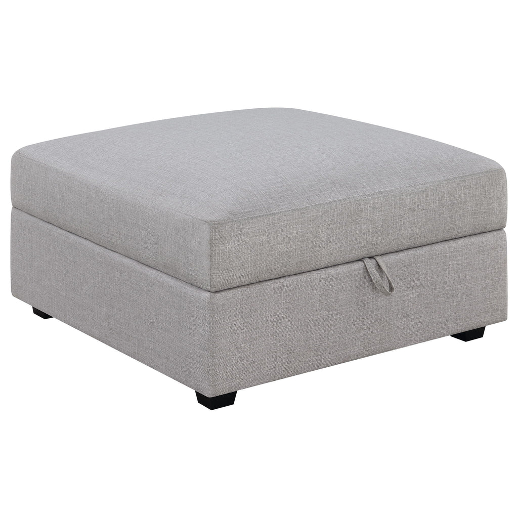 Grey upholstered ottoman-style module with stitched arm detail and black feet