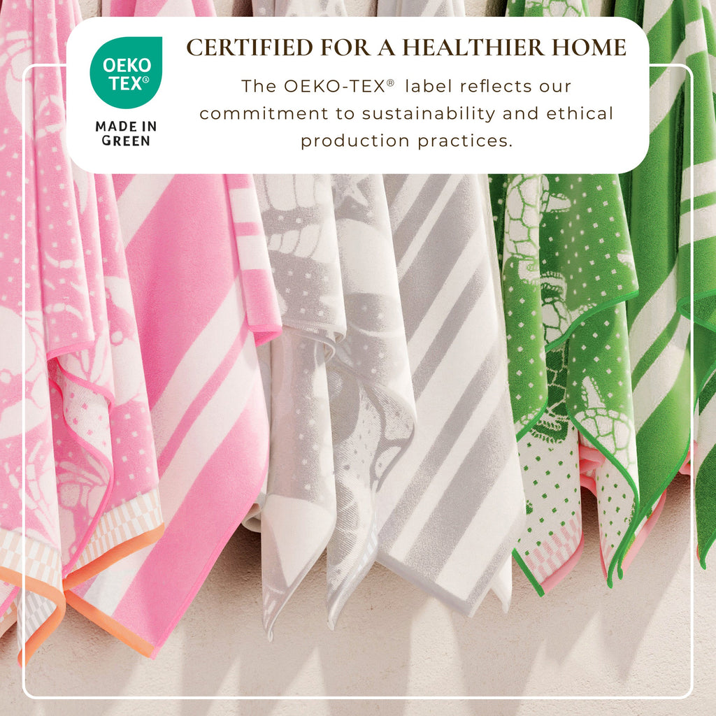 Multi-color cotton velour beach towels with printed designs, shown side by side