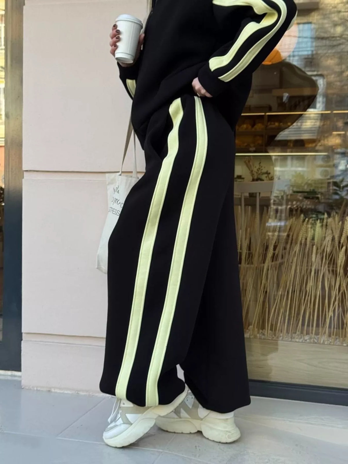 Black contrast-striped zip-up top and wide-leg pants set with lime stripe pant legs.