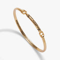 Gold Crayola metal crayon tension bangle with square clasp and engraved slogan