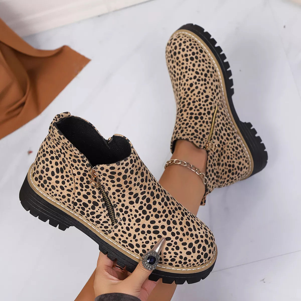 Leopard print ankle boots with side zipper and chunky black tread sole