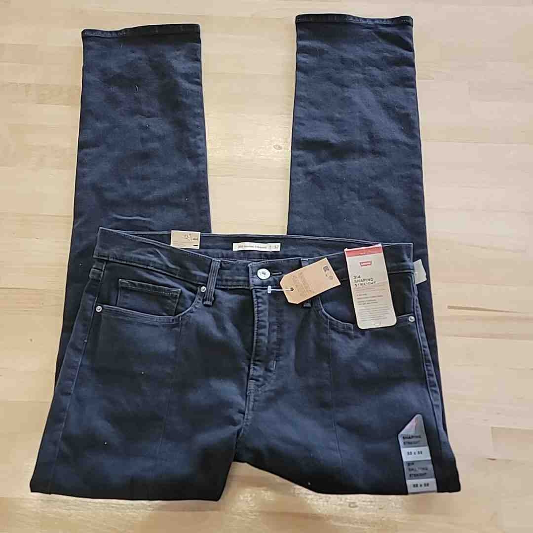 Dark blue straight-leg jeans with belt loops, button fly, and attached tags