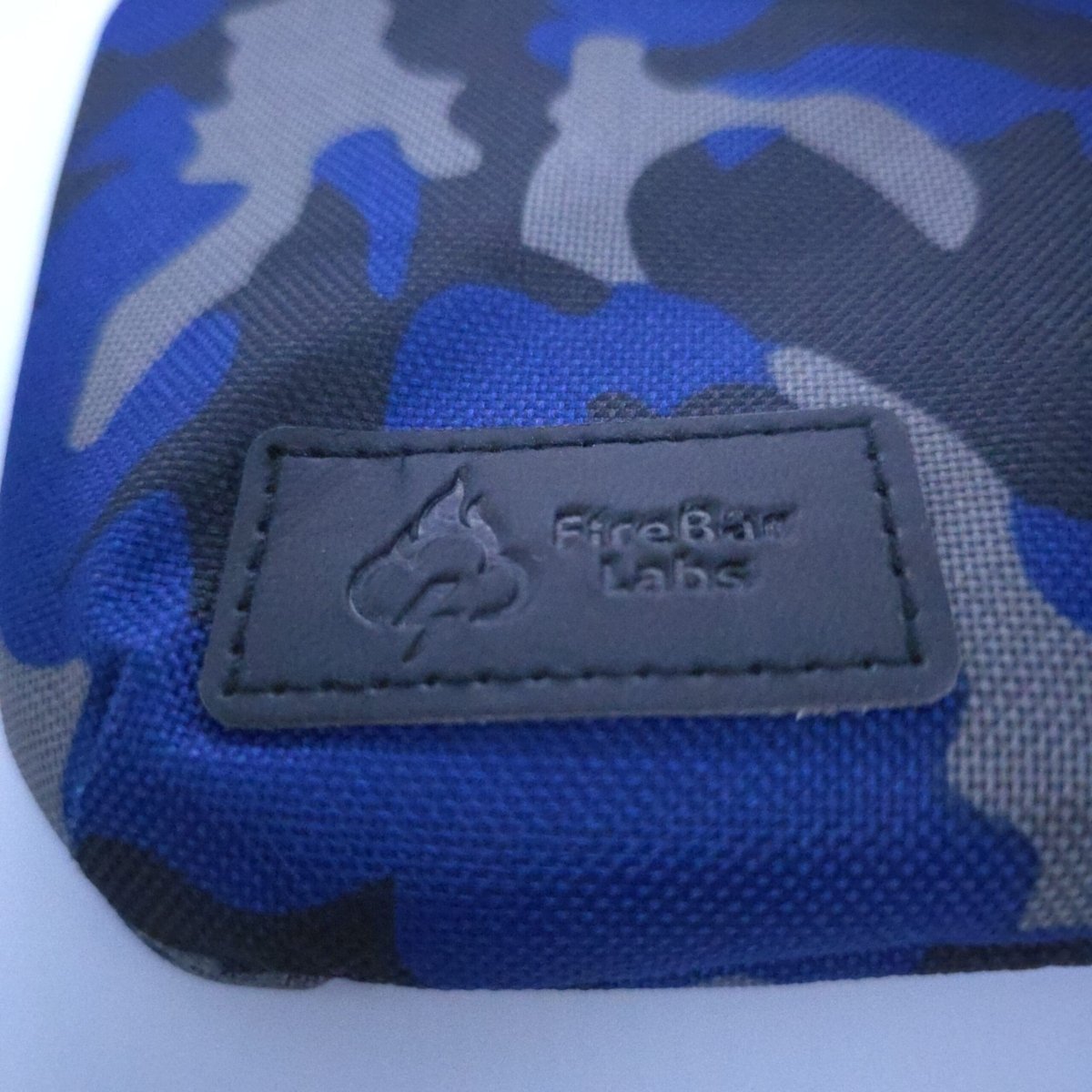 Smell-proof crossbody bag label patch on blue camouflage fabric