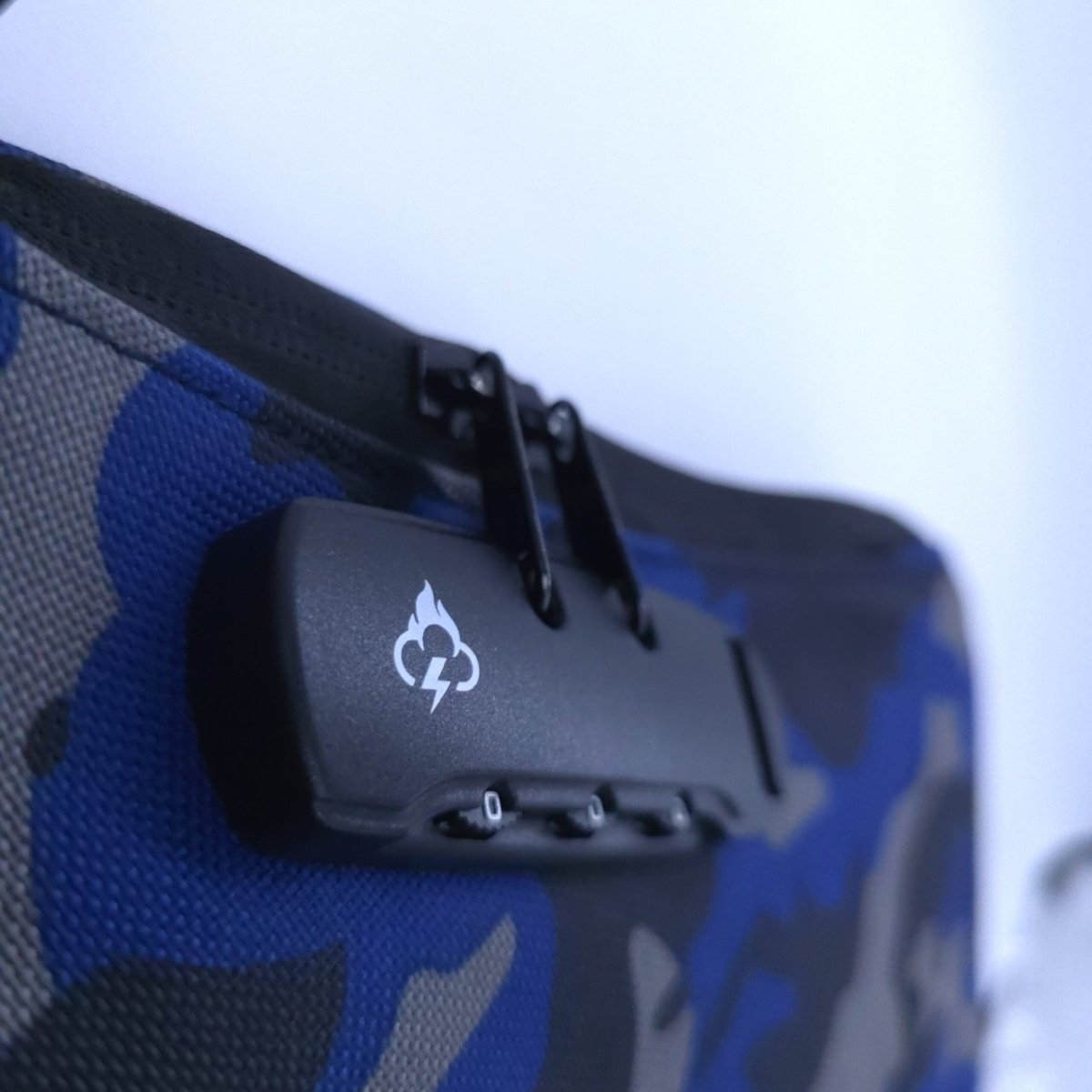 Smell-proof crossbody bag with black hidden lock on blue camouflage fabric