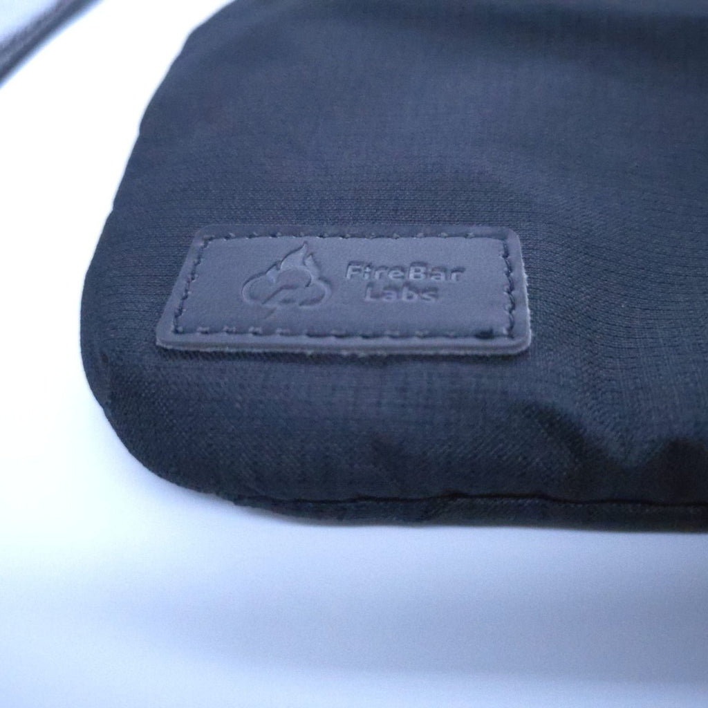 Smell-proof crossbody bag stitched logo patch on dark fabric