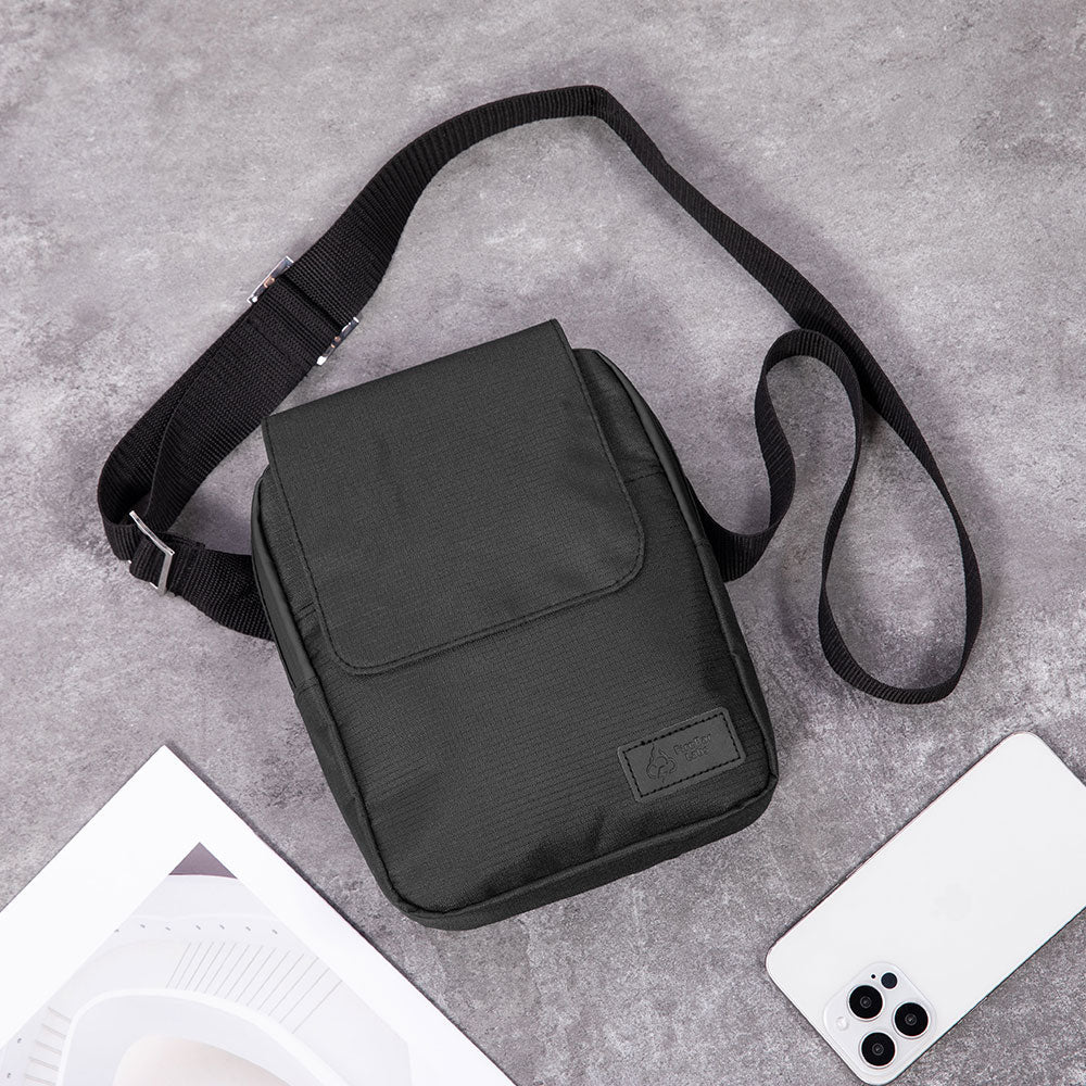 Black ripstop messenger bag with flap, stitched seams, and adjustable crossbody strap.