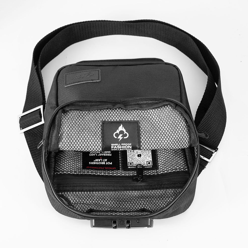 Black messenger bag interior with mesh-lined compartment, zipper, and label panel.