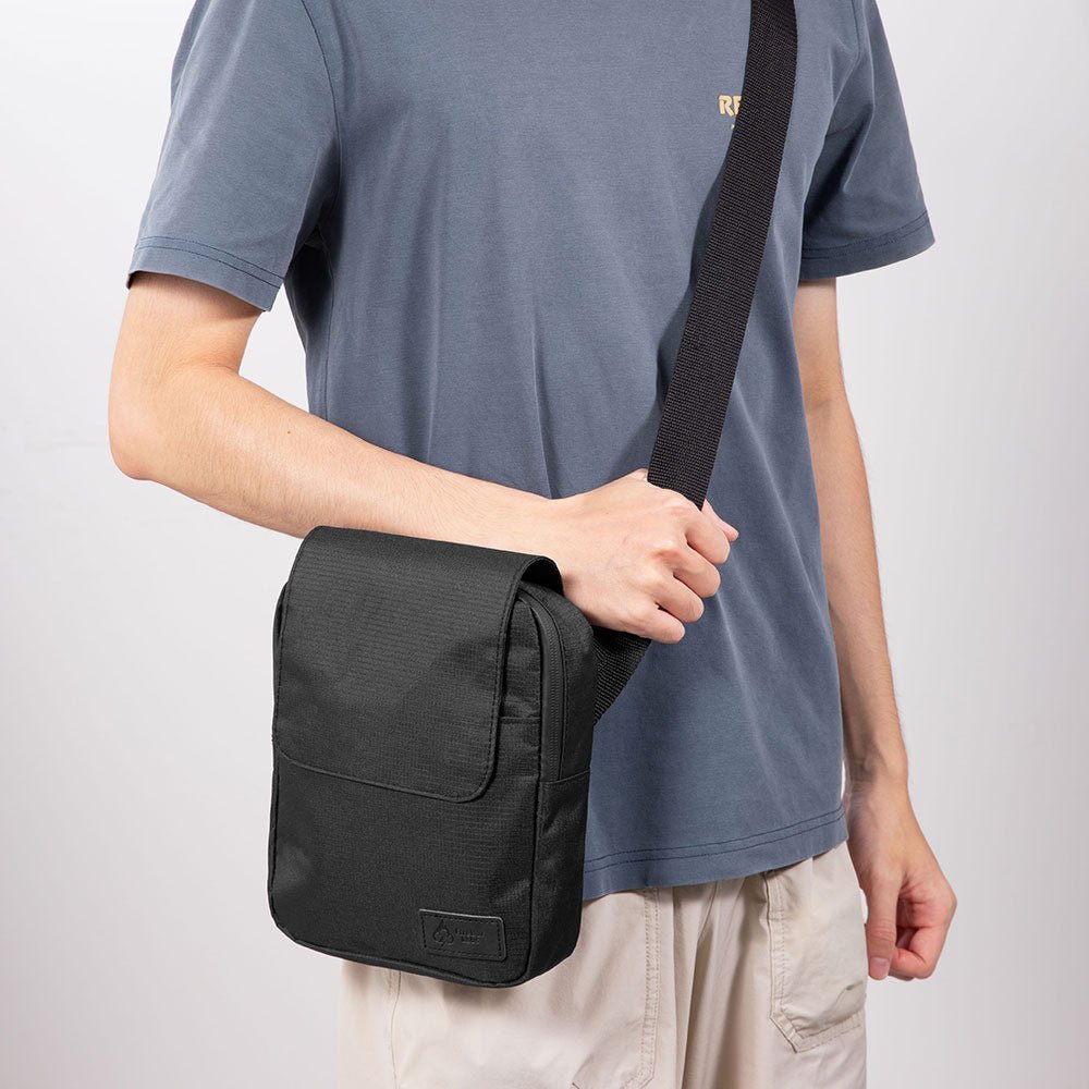 Black ripstop messenger bag with front flap pocket and adjustable shoulder strap