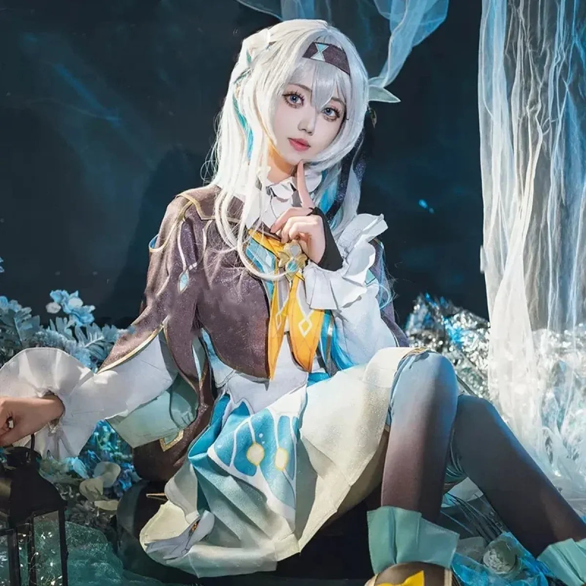 Model wearing cosplay outfit with brown bodice, gold trim, light blue skirt, and white gloves