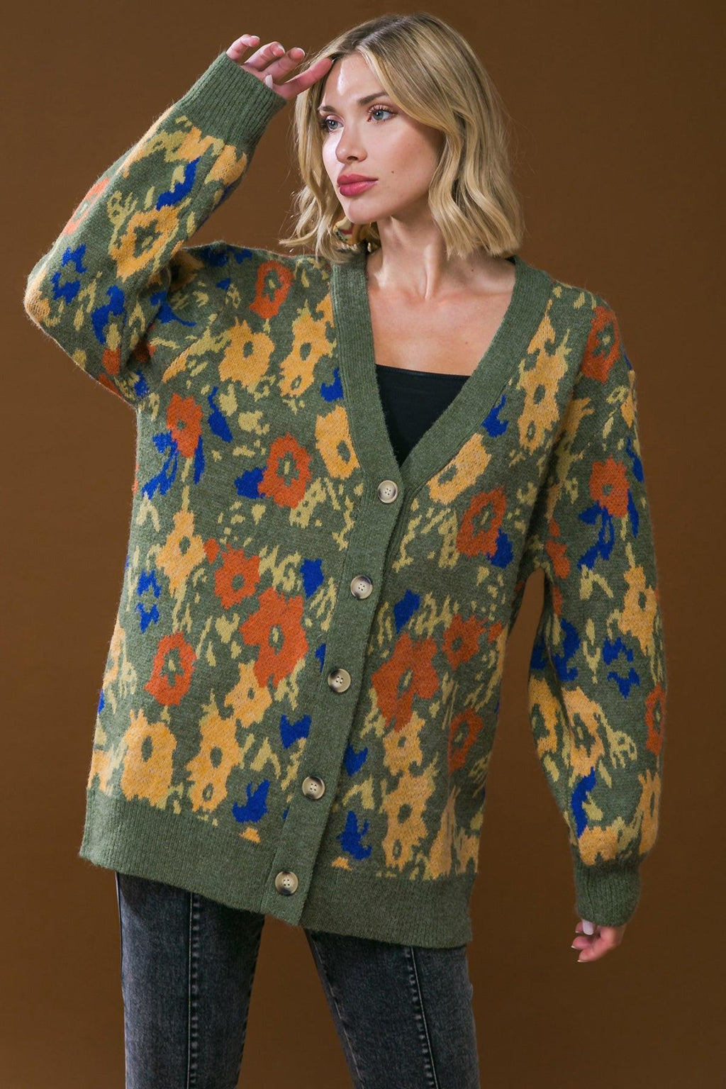 Olive button-front cardigan sweater with multicolor abstract pattern and ribbed hem