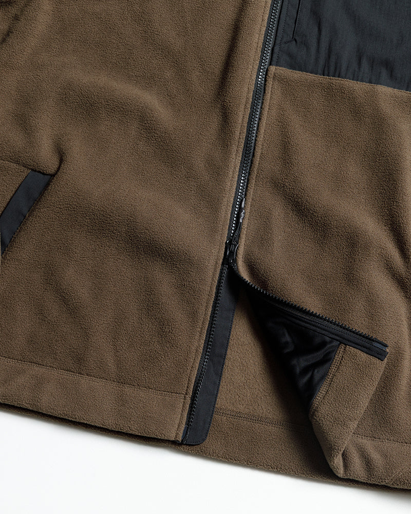 Close-up of brown two-tone fleece zip-up jacket front, zipper pocket and stitching.