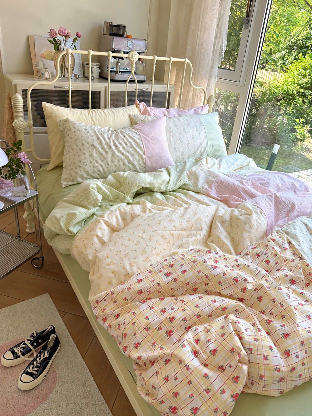 Pastel floral duvet cover set with mint, pink, and white pillows and quilted bedding