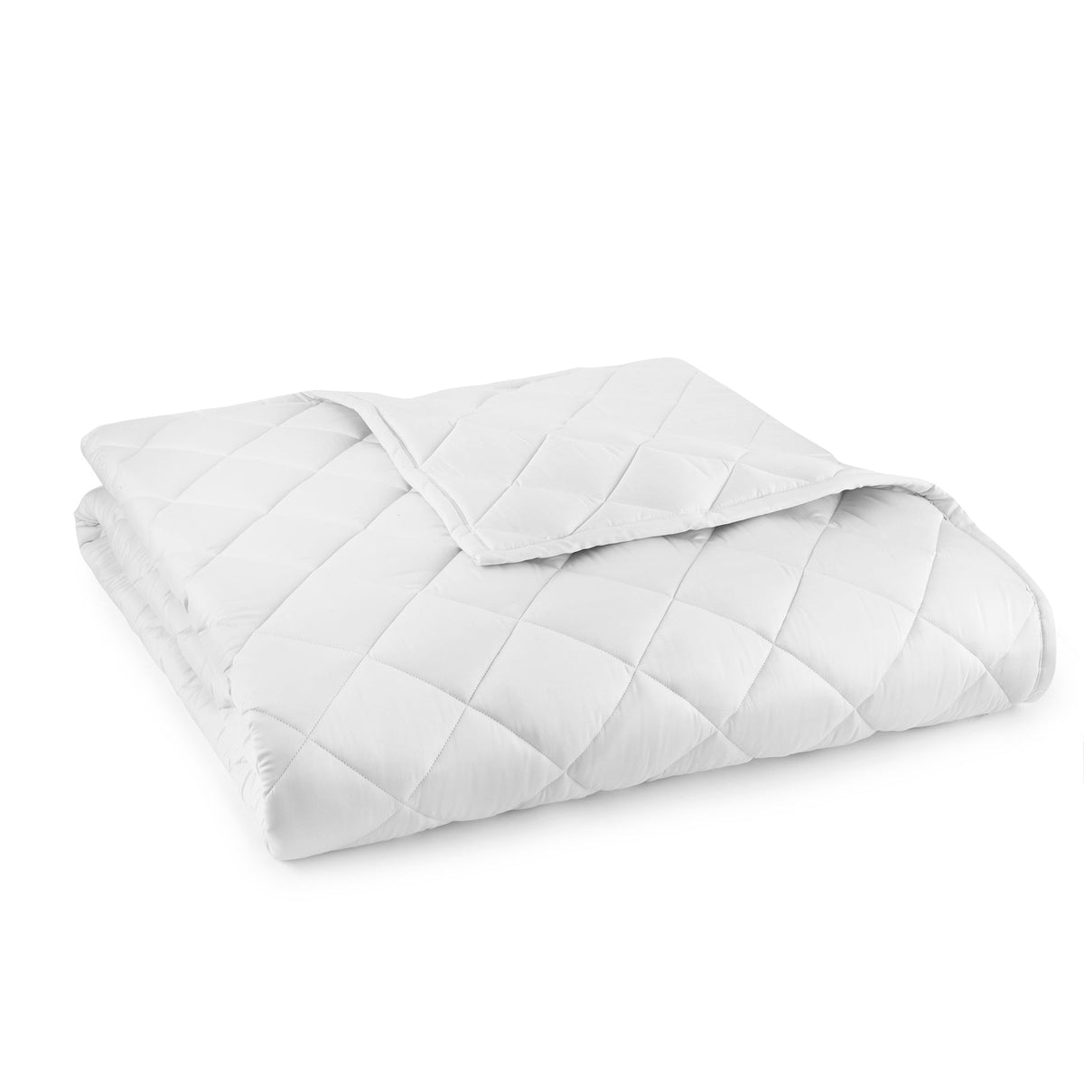 White quilted comforter, neatly folded with stitched channels