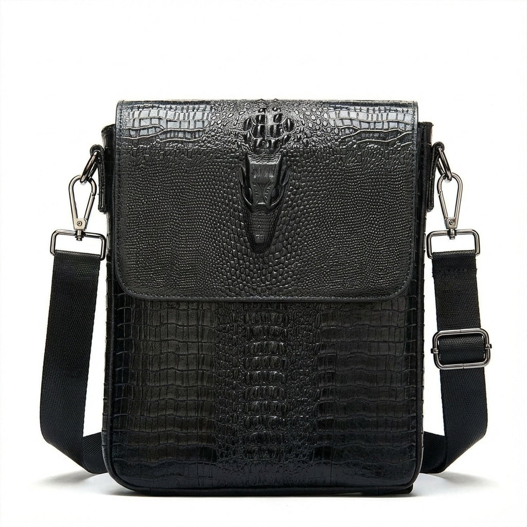 Front view black croc-embossed leather sling bag with snap flap and shoulder strap