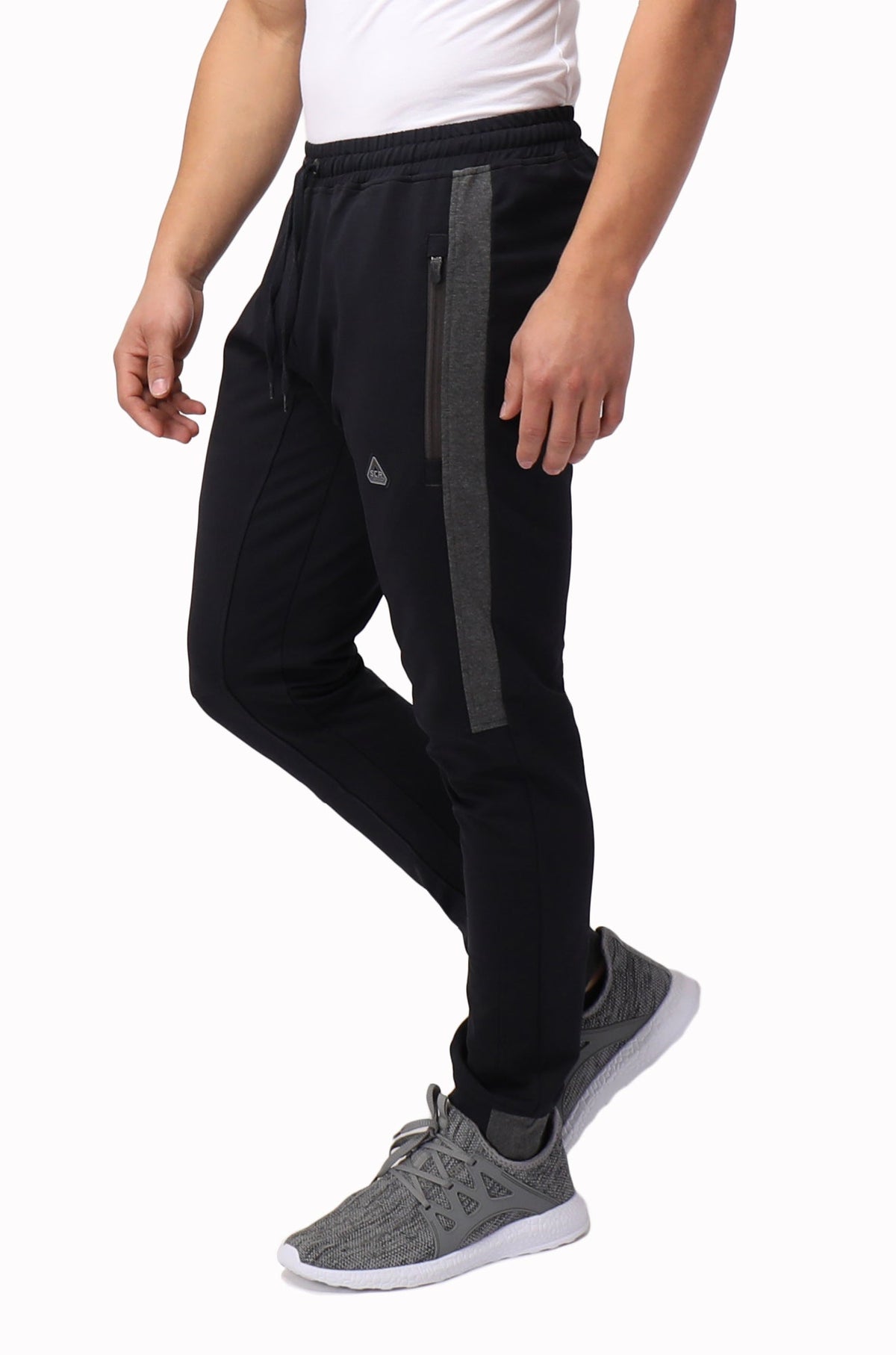 Tall fit jogger pants in dark black with grey vertical stripe and tapered leg.