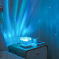 Frutiger RGB bedroom nightlight projector with blue laser-style light beam, rectangular base