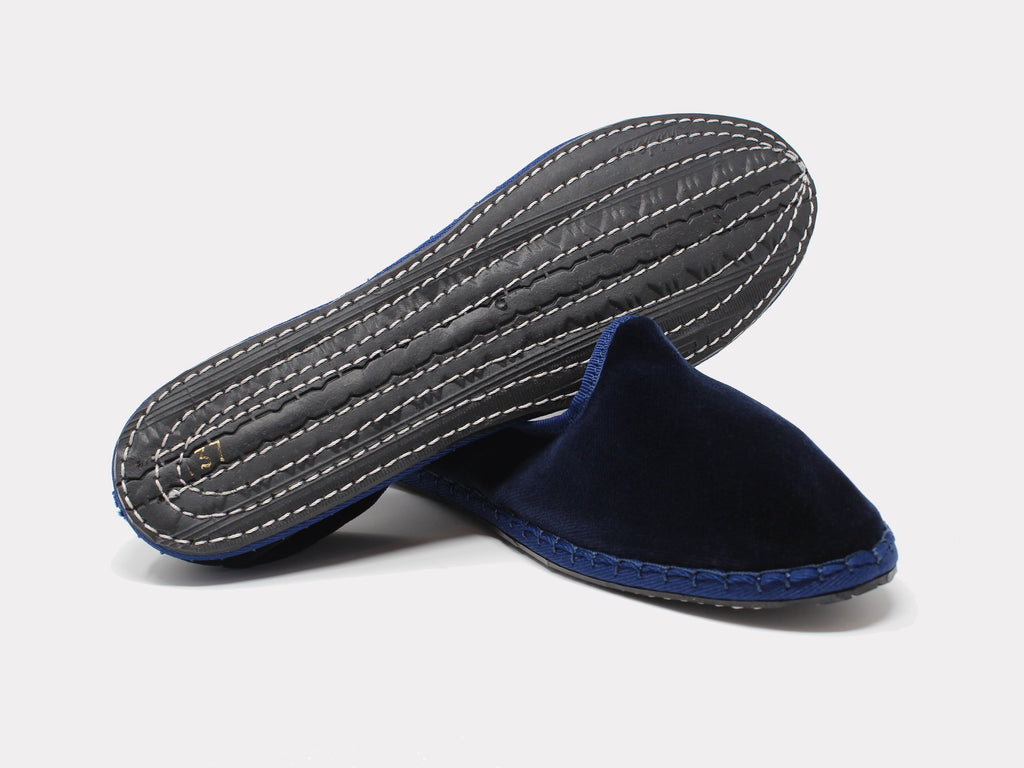 Navy velvet slip-on loafer with contrast blue trim and white stitching on sole