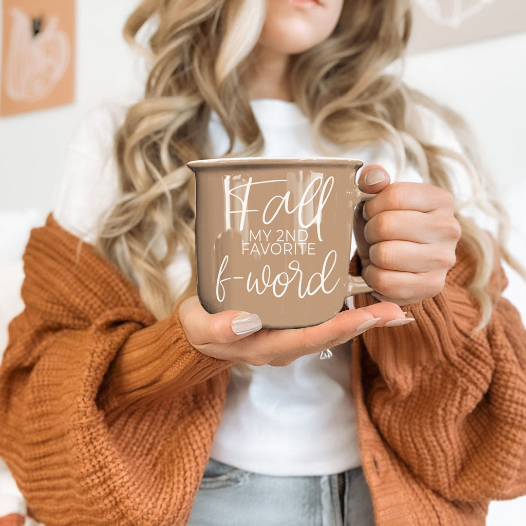 Hand holding taupe mug showing 'Fall my 2nd favorite f-word' print