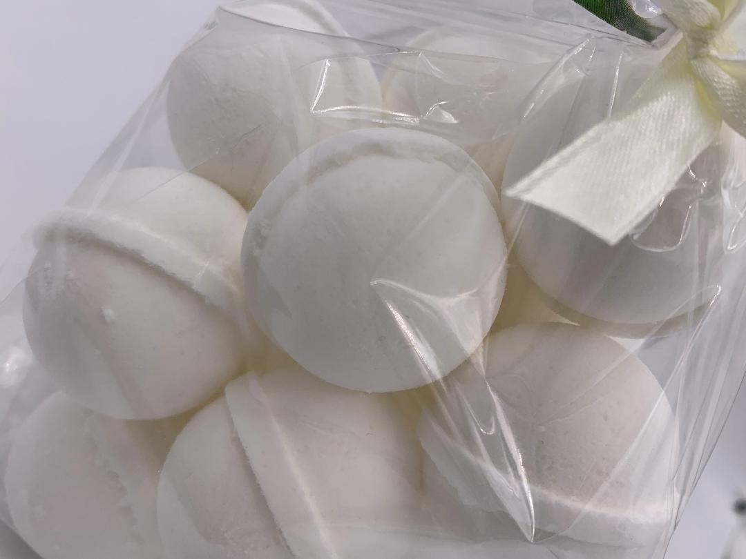 White bath bomb balls with embossed texture, sealed in clear bag