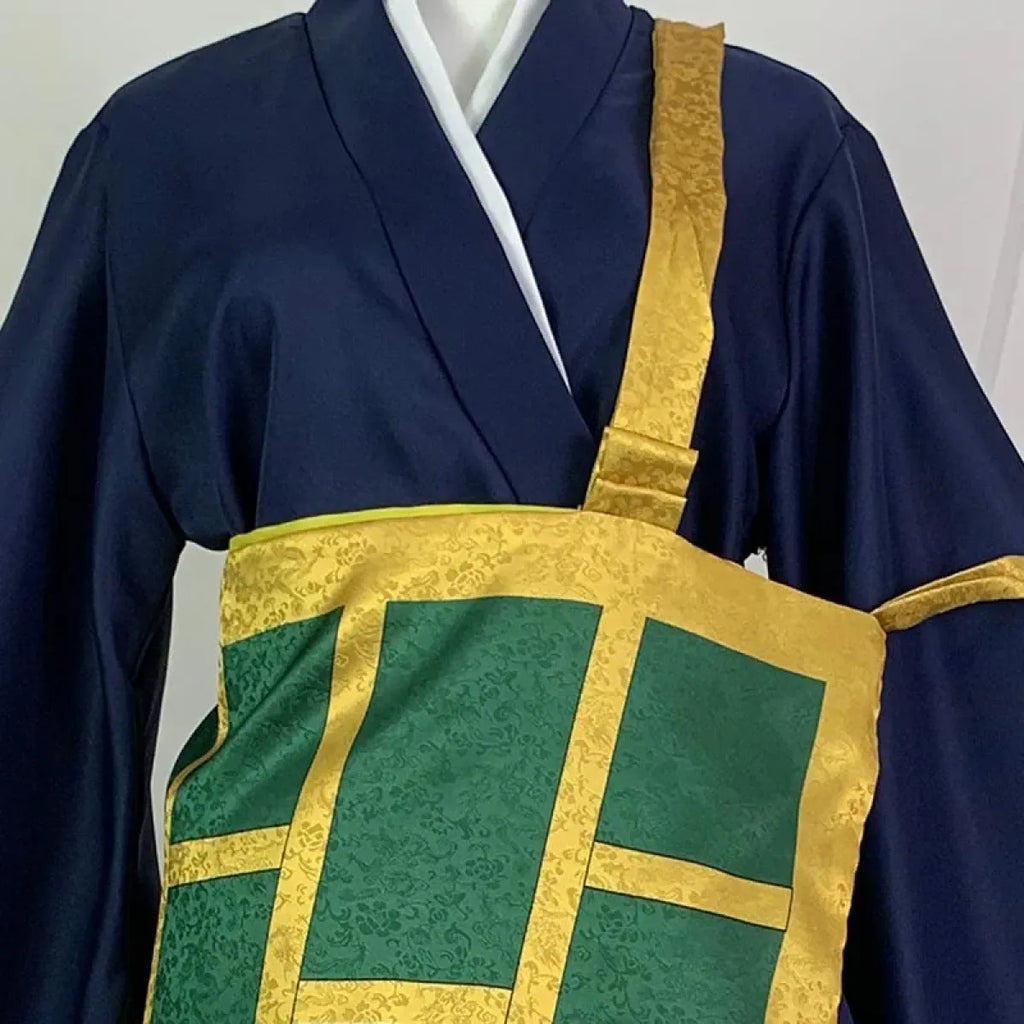 Navy kimono cosplay close-up with gold-edged green rectangle panel and textured fabric