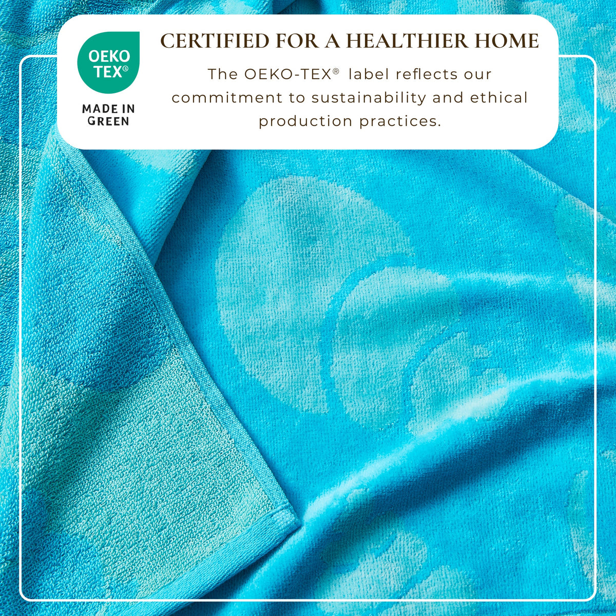 Blue cotton velour beach towel, folded with visible pile and sheen
