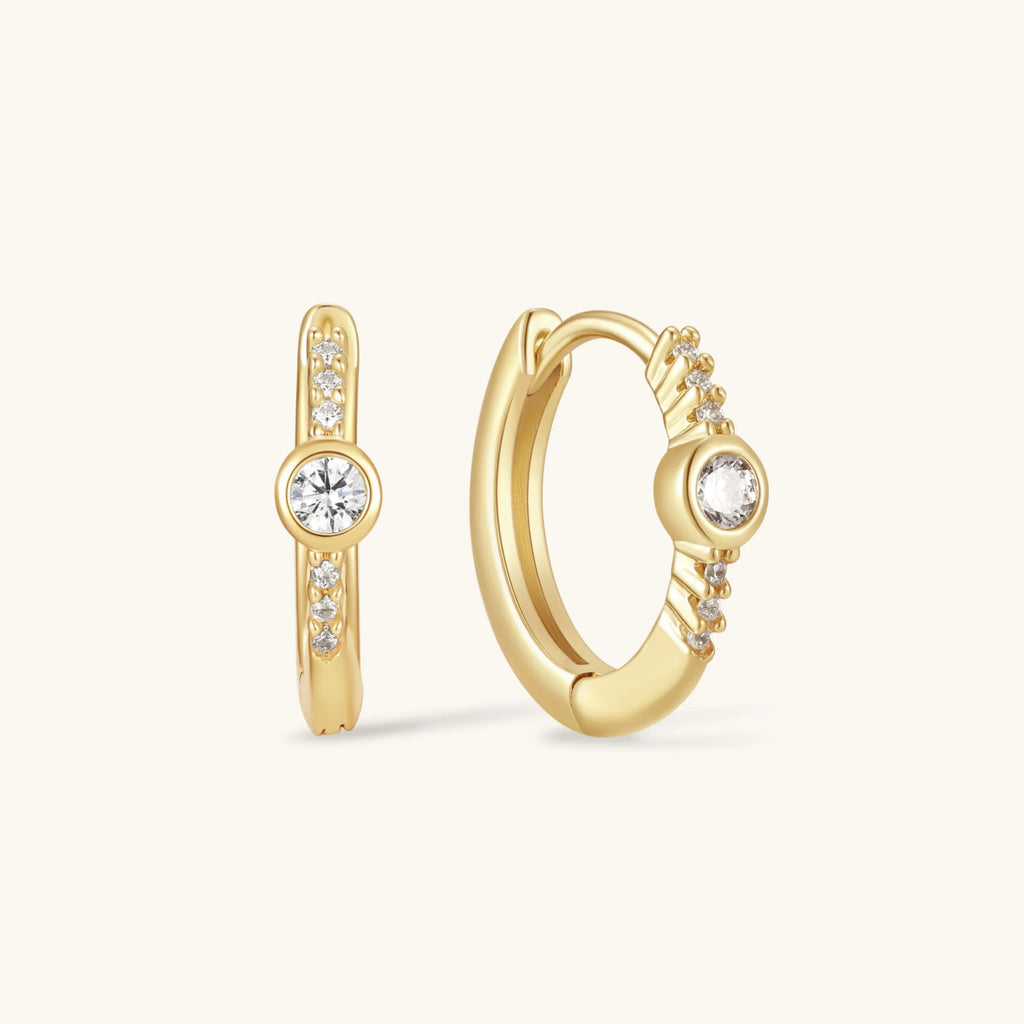 Gold bezel hoop earrings with round clear stones and pavé accents
