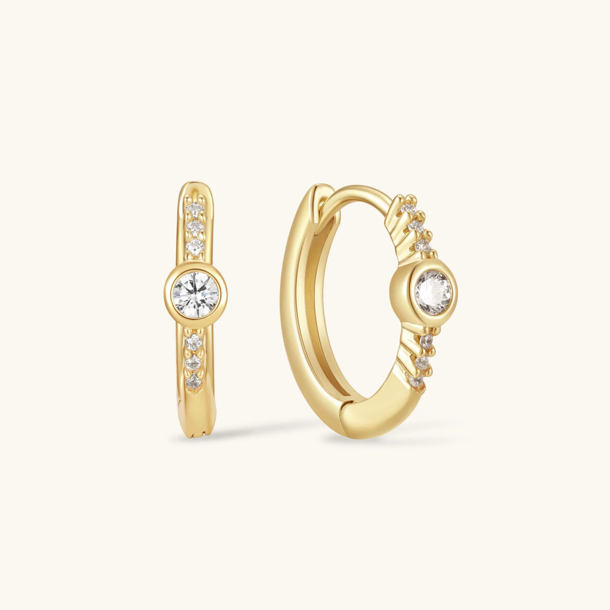 Gold bezel hoop earrings with round clear stones and pavé accents