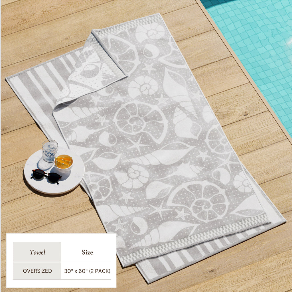 Gray cotton velour beach towel with white sea-life pattern and striped trim