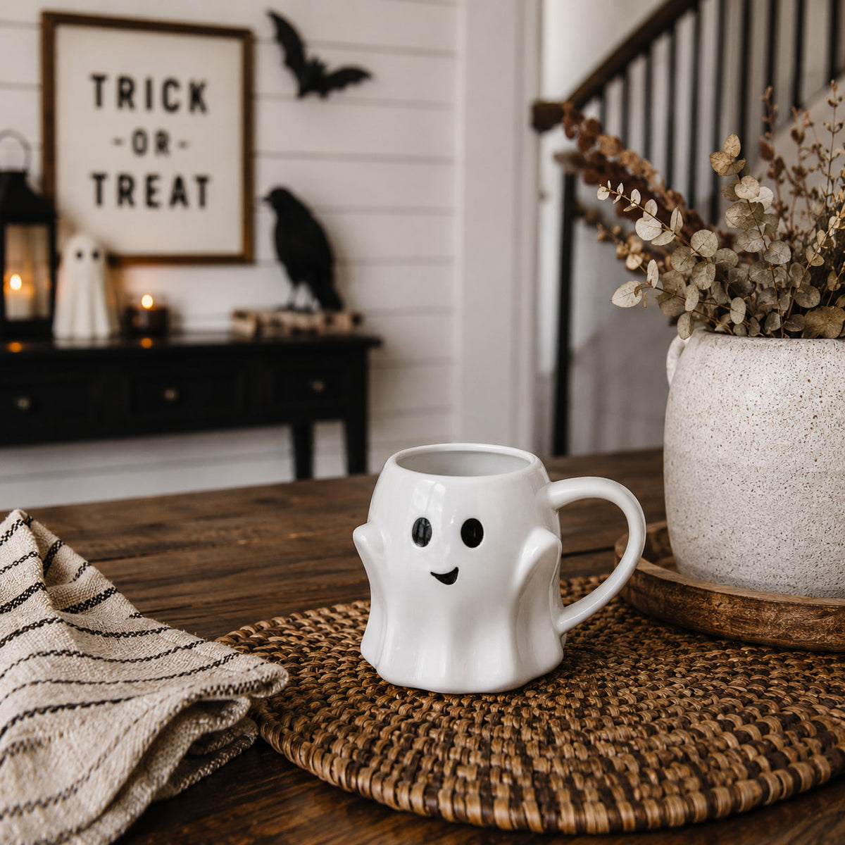 White ghost-shaped mug with smiley face and handle