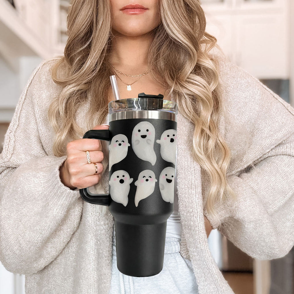 Close-up of black 40oz tumbler with cute white ghosts and clear straw lid