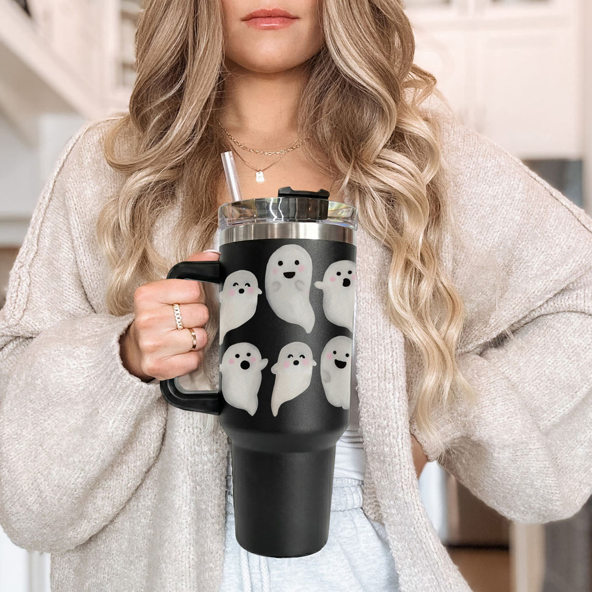 Close-up of black 40oz tumbler with cute white ghosts and clear straw lid