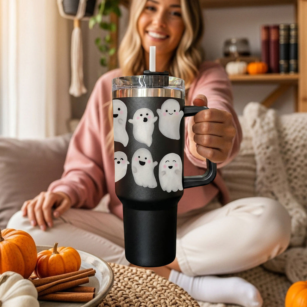 Black 40oz tumbler with ghost faces, clear lid, straw, and side handle held up