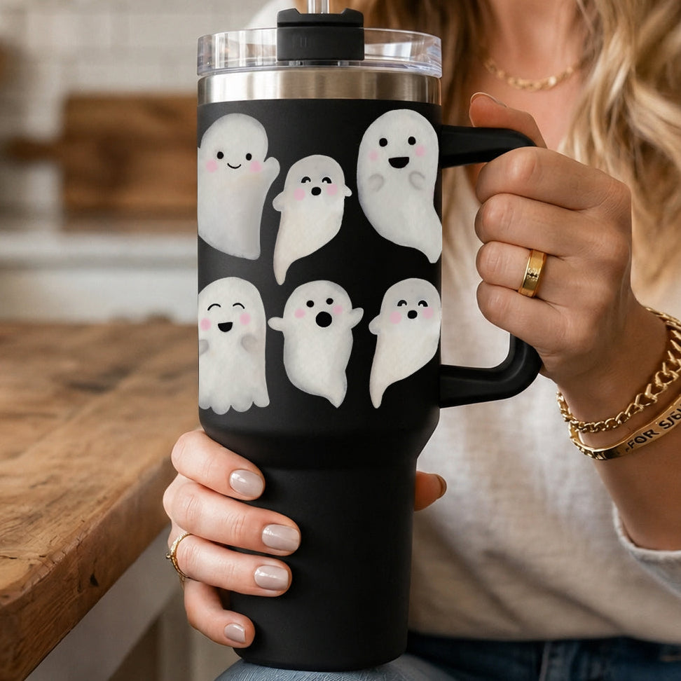 Close-up of hands gripping 40oz black ghost tumbler with clear lid and handle