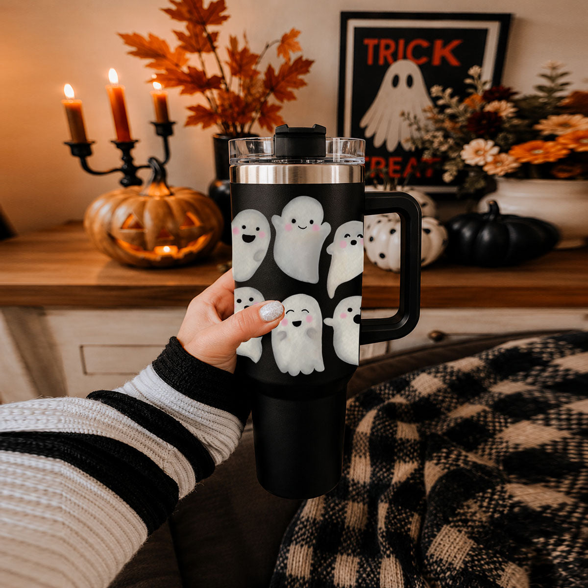 Hands holding 40oz black ghost tumbler with clear lid and mug handle