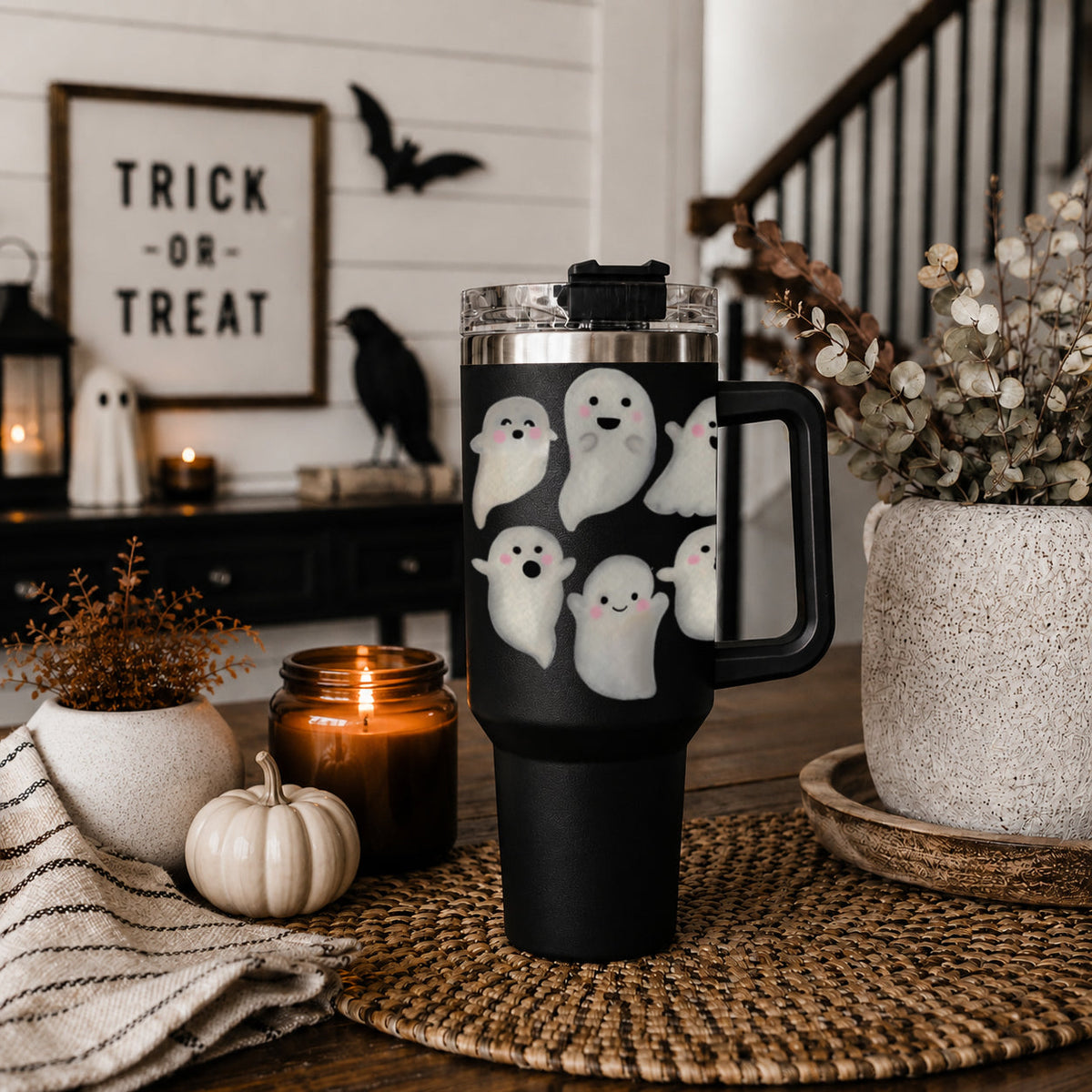 Black 40oz ghost tumbler on a table with clear lid and side handle
