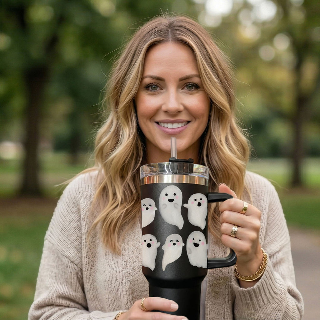 Smiling woman holding 40oz black ghost tumbler with clear lid and handle