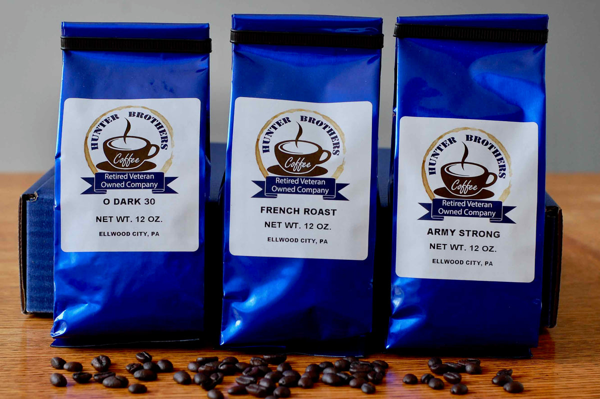 Dark roast coffee gift pack with three blue bags, assorted roast labels