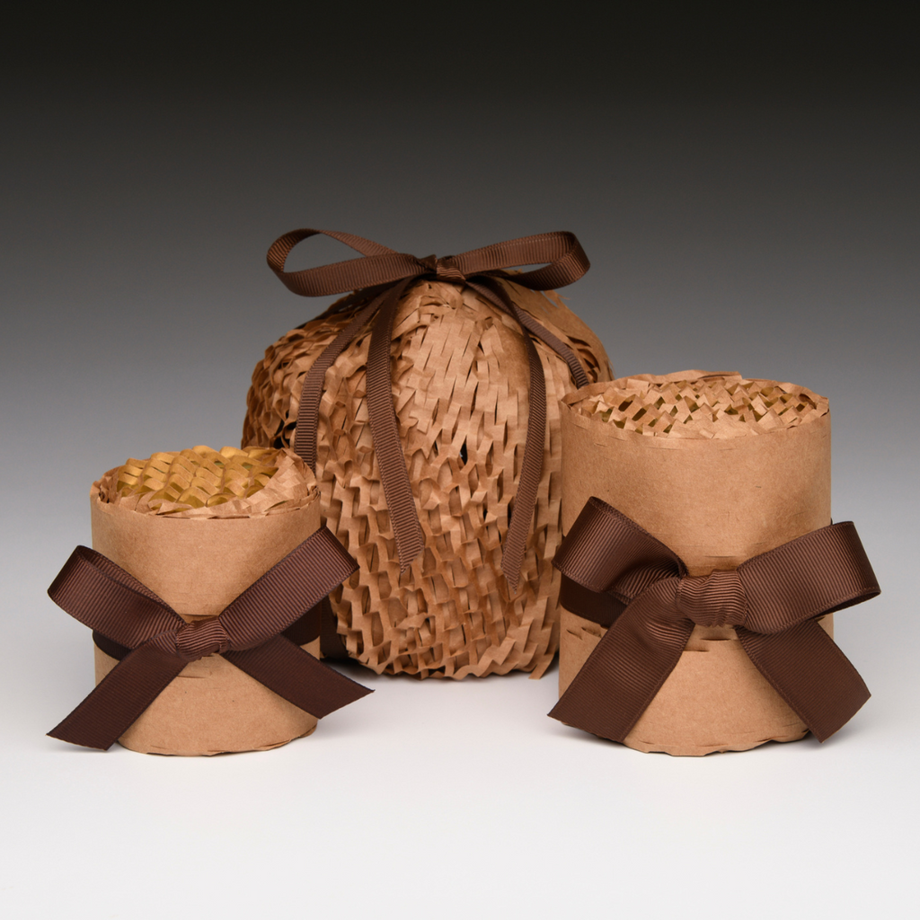 Raffia-wrapped gift candle holder with brown ribbon bows and paper wrap