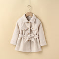 Girls' mid-length cream coat with button front, belt tie, and flap pockets
