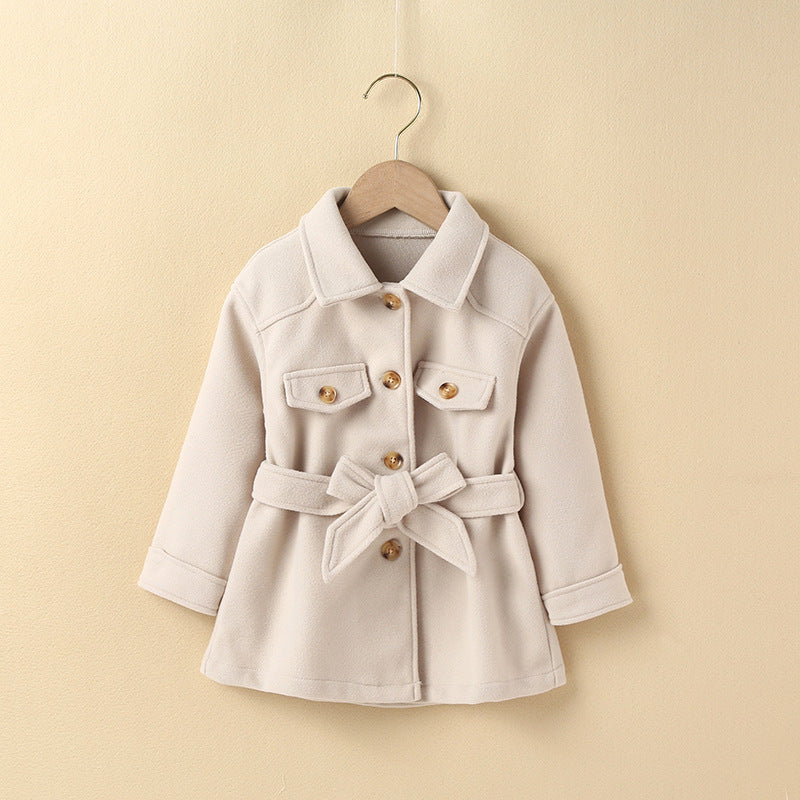 Girls' mid-length cream coat with button front, belt tie, and flap pockets