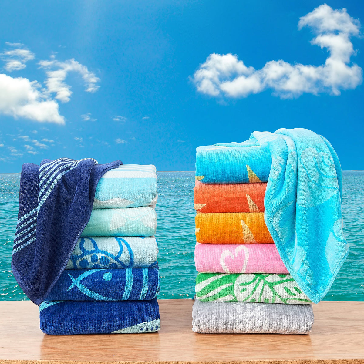 Stack of multicolor cotton velour beach towels with striped and fish patterns, folded